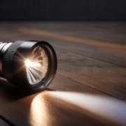 Close-up of a flashlight shining on the floor.